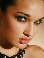 Exotic dark featured model has tall boots she will walk over anyone with.