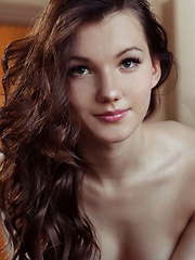 Iva bares her petite body and delectable pussy on the chair.